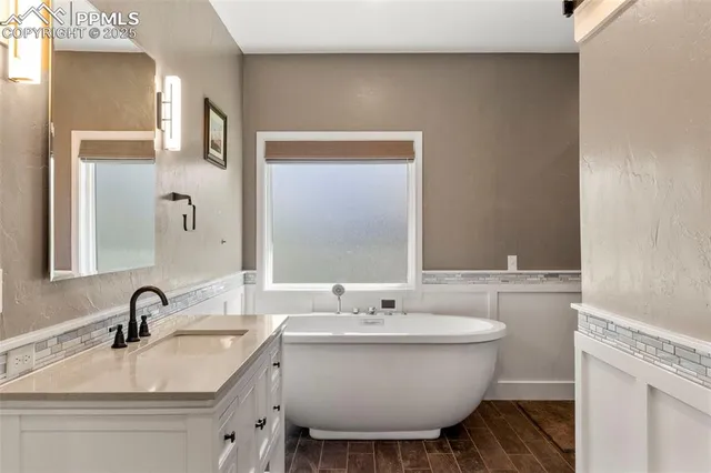 a view of walk in closet with clothes