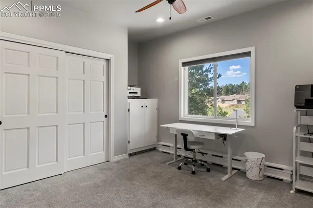 a kitchen with stainless steel appliances a table and chairs in it