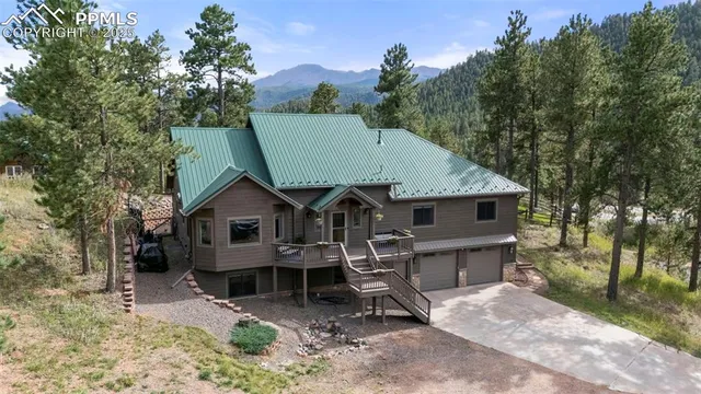 an aerial view of house with yard and mountain view in back