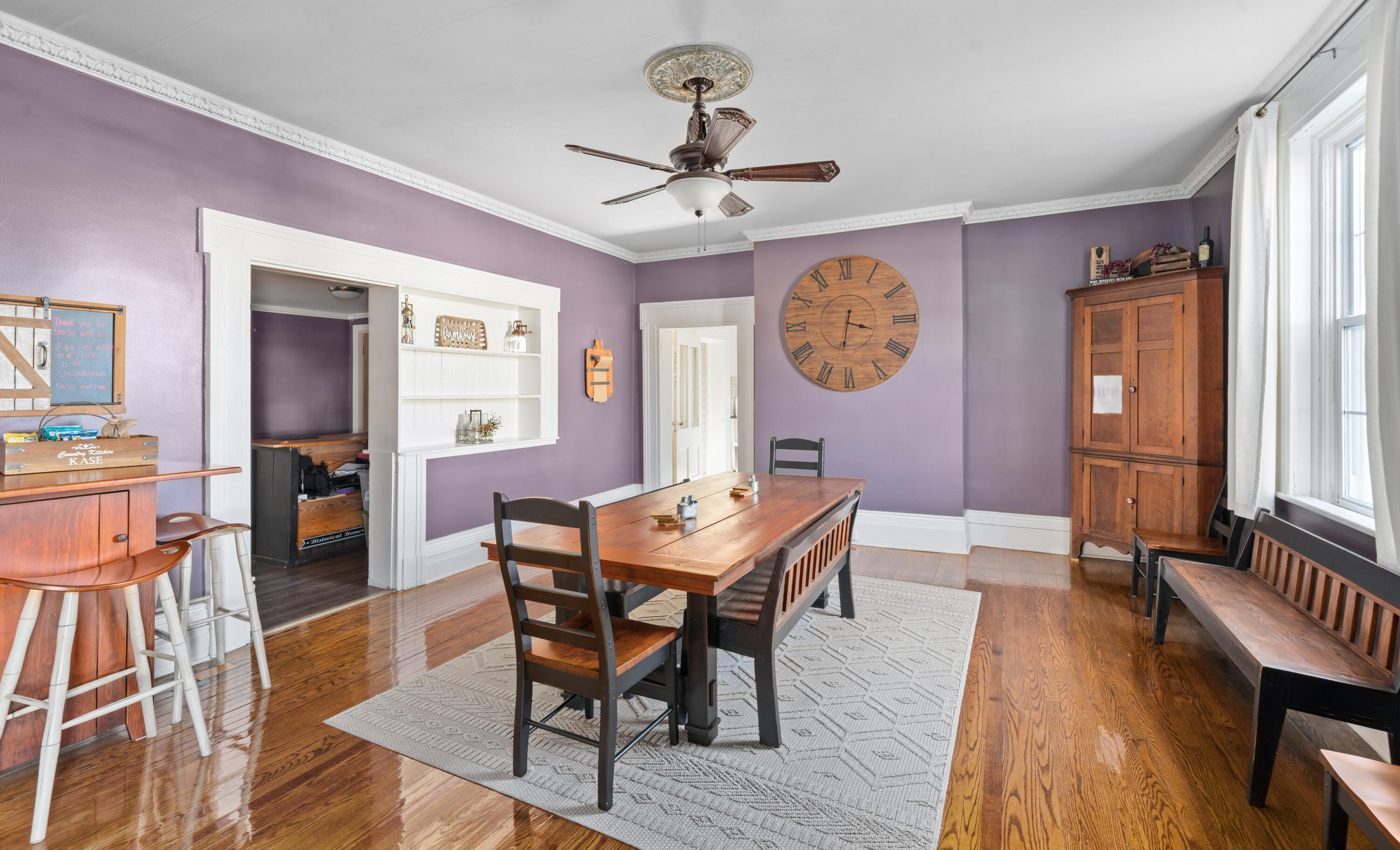 19391 Main Street Buchanan, VA 24066 - Photo 14 of 34 a dining room with wooden floor a chandelier a wooden table and chairs