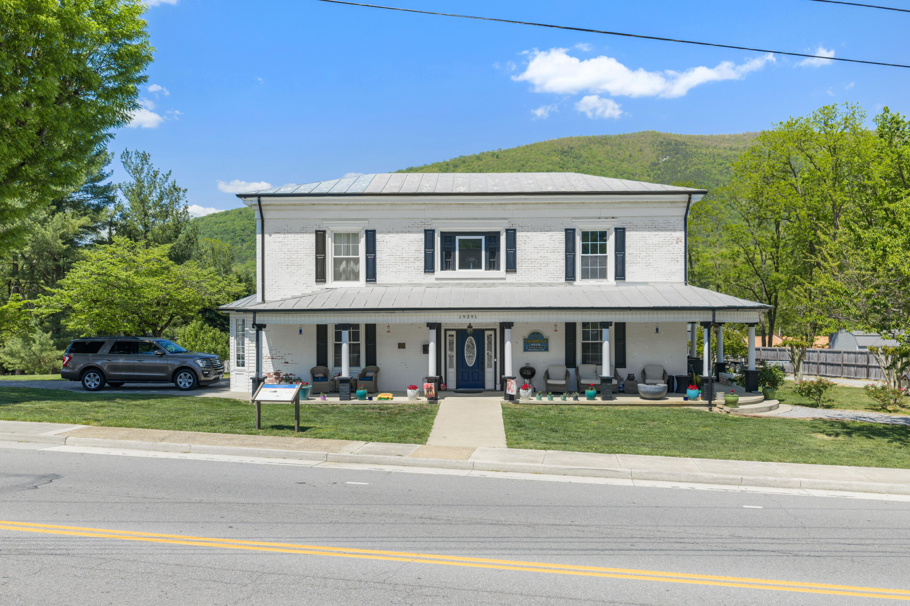 19391 Main Street Buchanan, VA 24066 - Photo 2 of 34 a front view of a house with a garden and plants