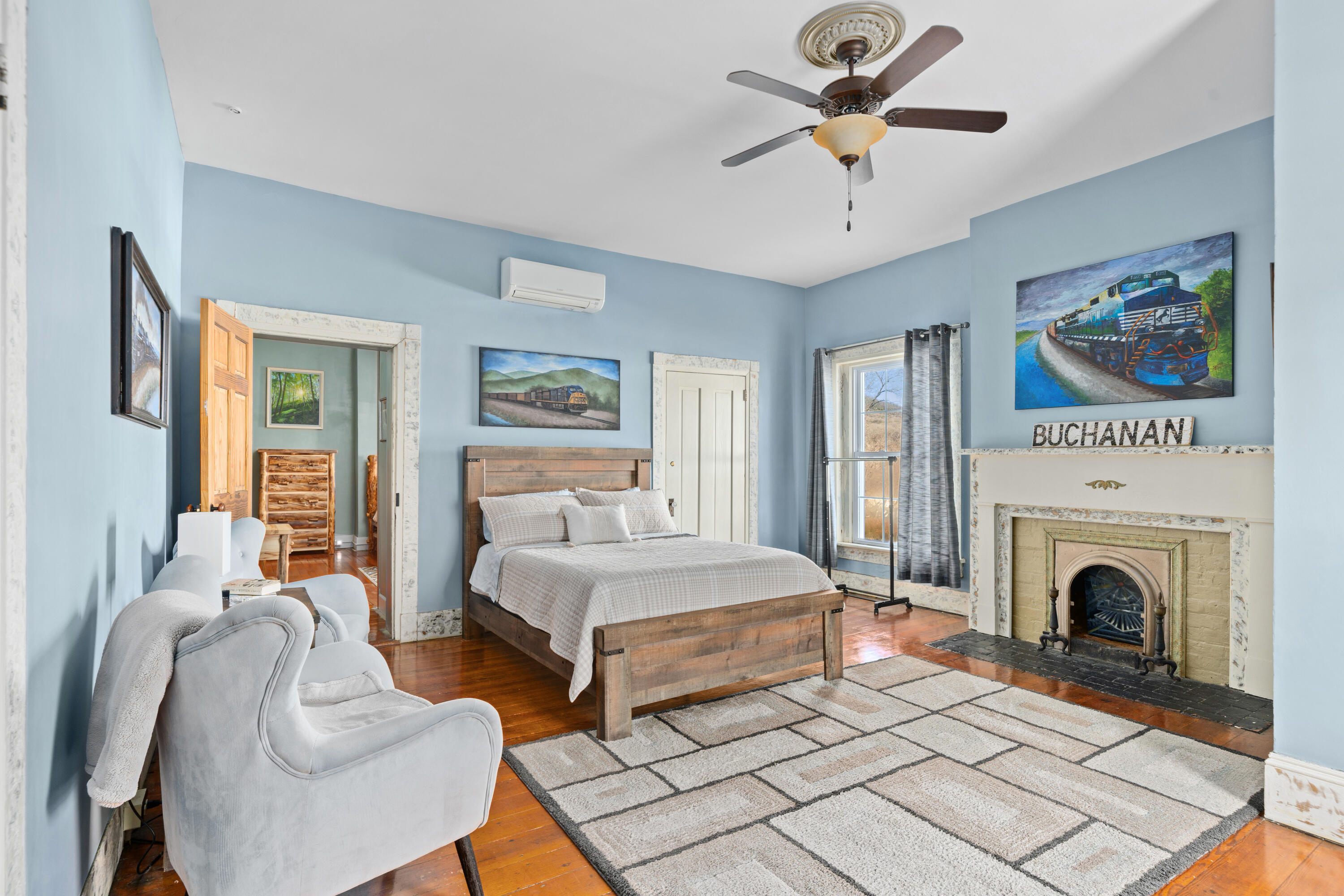 19391 Main Street Buchanan, VA 24066 - Photo 30 of 34 a spacious bedroom with two beds and a fireplace