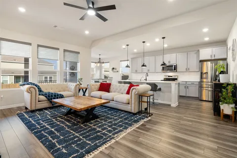 a living room with furniture and kitchen view