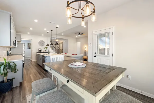 an open kitchen with kitchen island a stove and a table