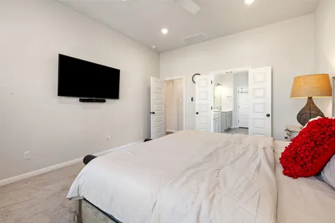 a bedroom with a bed and a flat screen tv