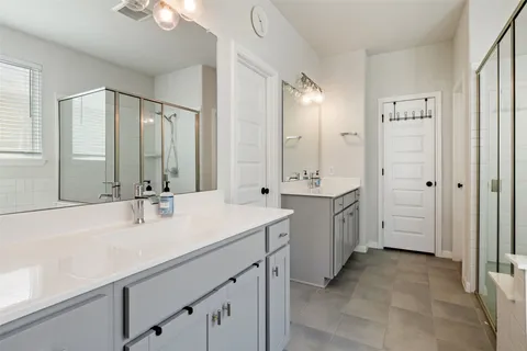 a bathroom with a double vanity sink mirror and double