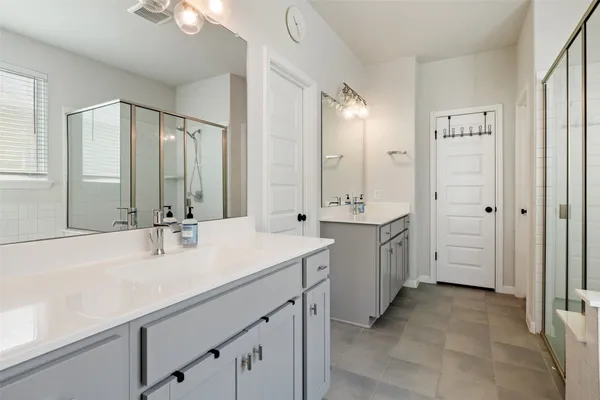 a bathroom with a double vanity sink mirror and double