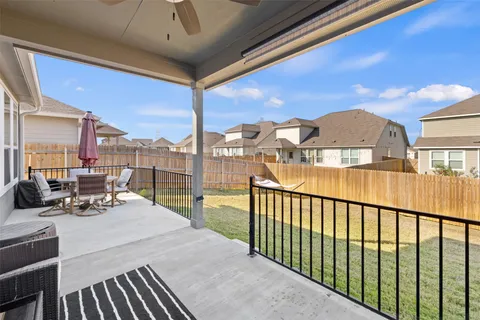 a view of a balcony with dining table and chairs