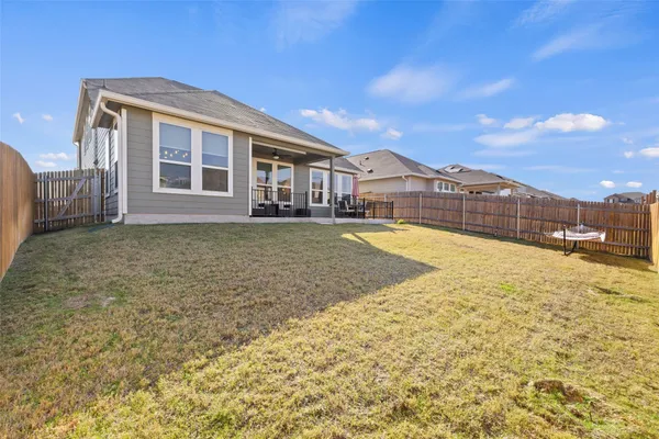 a view of a house with a swimming pool and a yard