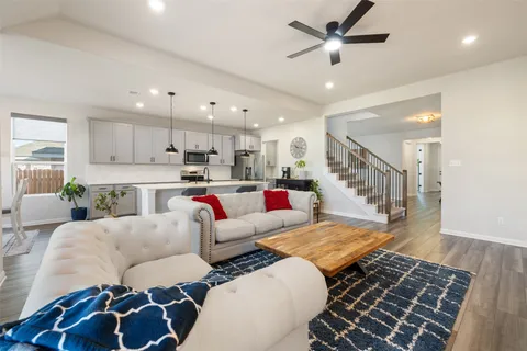 a living room with furniture and kitchen view