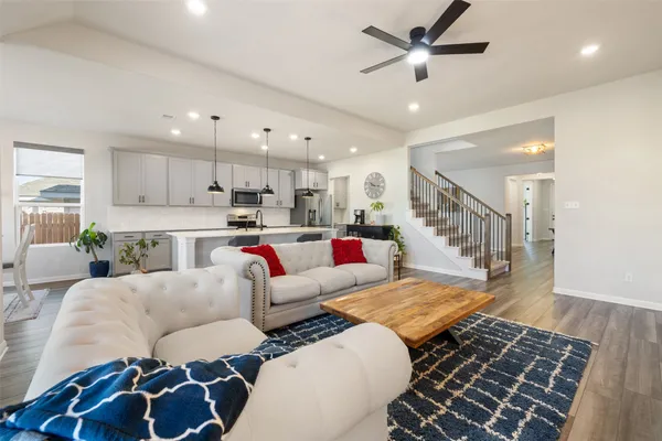 a living room with furniture and kitchen view