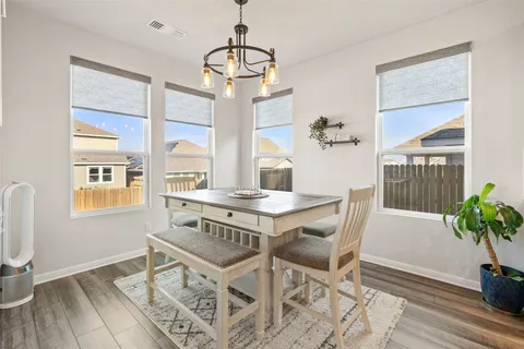 a view of a dining room with furniture window and wooden floor