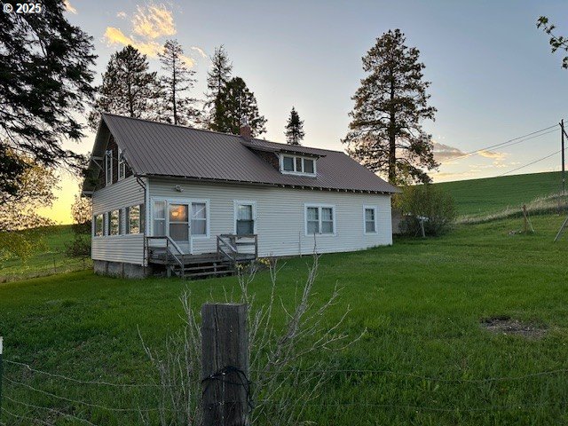 21 B Howard Road Palouse, WA 99161 - Photo 1 of 12 a backyard of a house with table and chairs plants and large tree