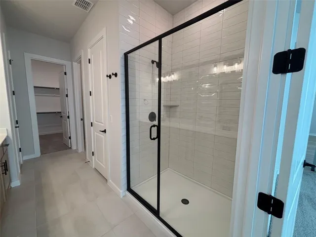 a bathroom with a glass shower door