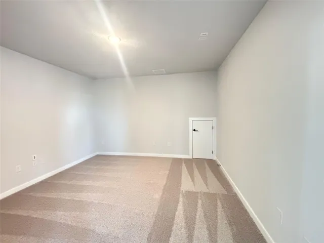 a view of an empty room and a window