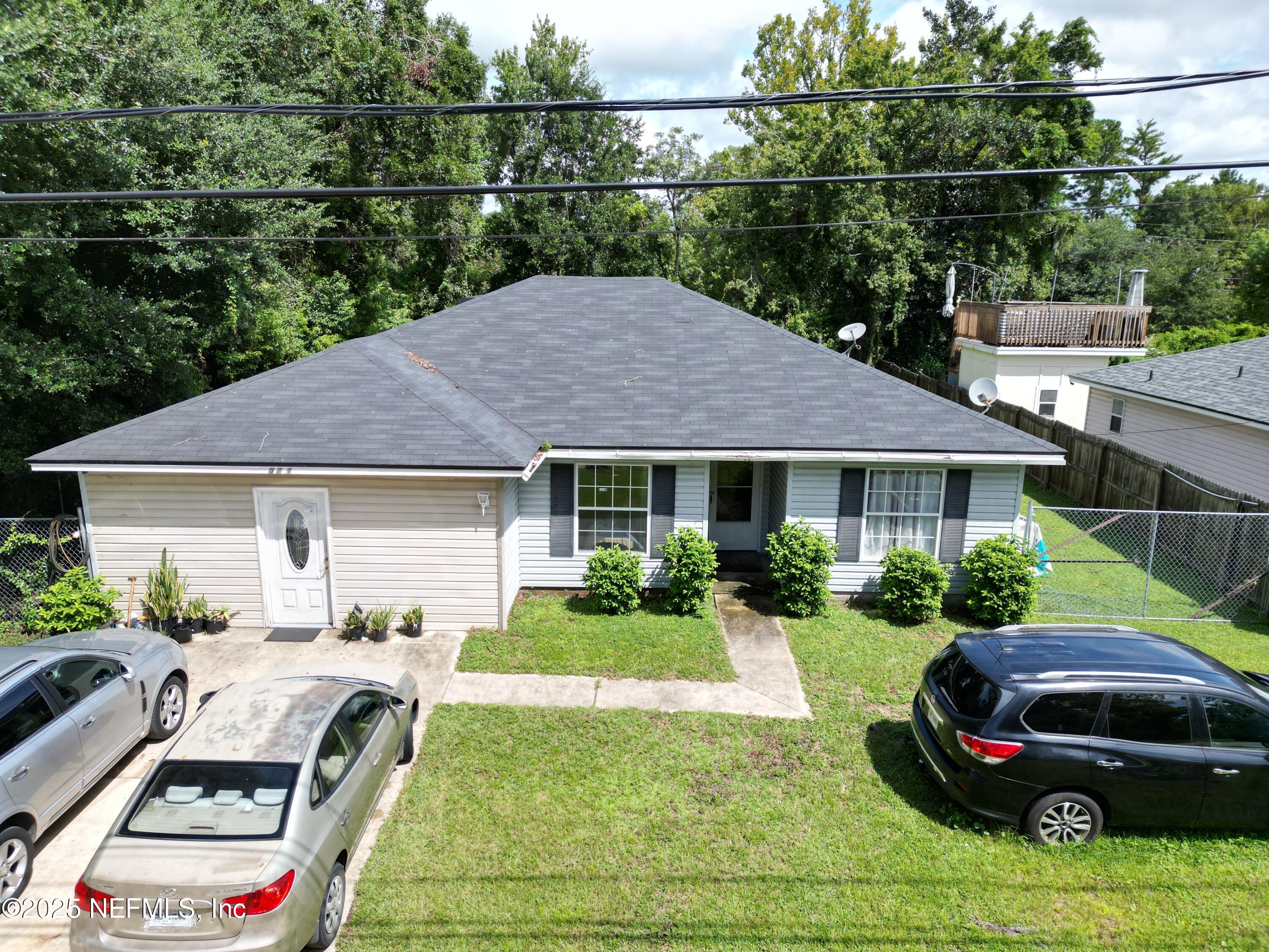 a view of a house with backyard sitting area and swimming pool