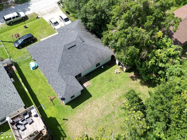 an aerial view of a house with a yard