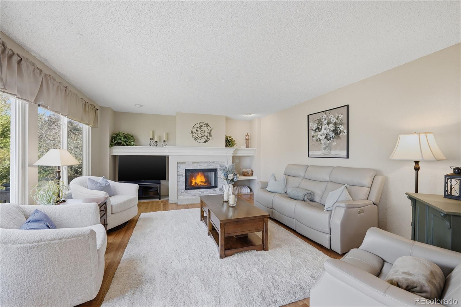 9264 Madras Court Highlands Ranch, CO 80130 - Photo 15 of 50 a living room with furniture and a fireplace