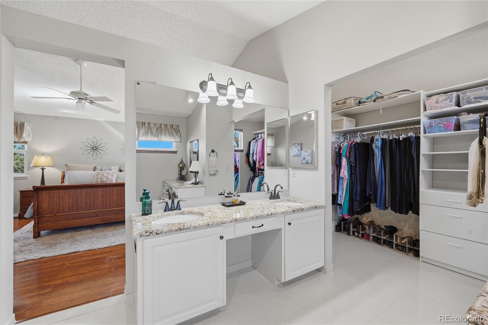 9264 Madras Court Highlands Ranch, CO 80130 - Photo 21 of 50 a bathroom with a double vanity sink mirror and shower