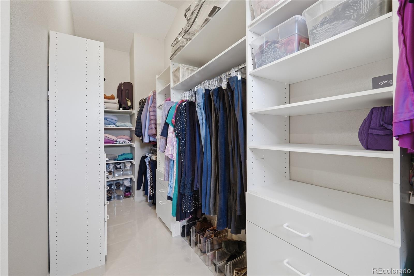 9264 Madras Court Highlands Ranch, CO 80130 - Photo 23 of 50 a view of walk in closet with clothes and shoes