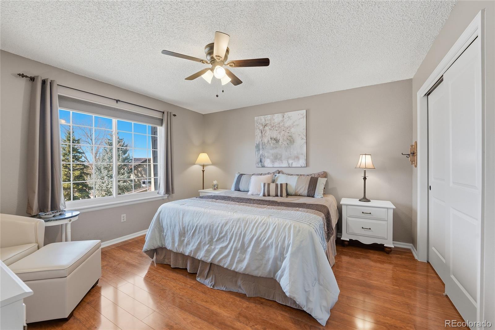 9264 Madras Court Highlands Ranch, CO 80130 - Photo 25 of 50 a bedroom with a large bed and a window