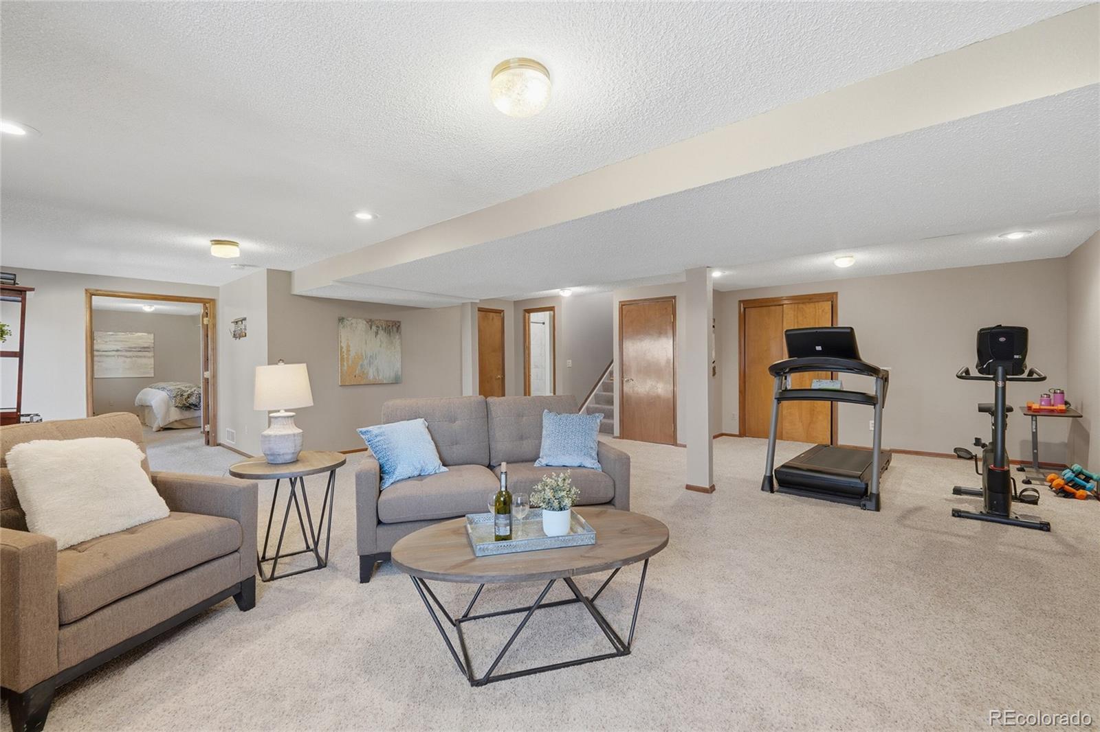 9264 Madras Court Highlands Ranch, CO 80130 - Photo 28 of 50 a living room with furniture and a flat screen tv