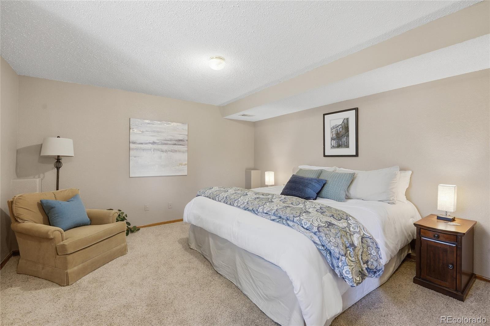 9264 Madras Court Highlands Ranch, CO 80130 - Photo 30 of 50 a bedroom with a bed couch and a window