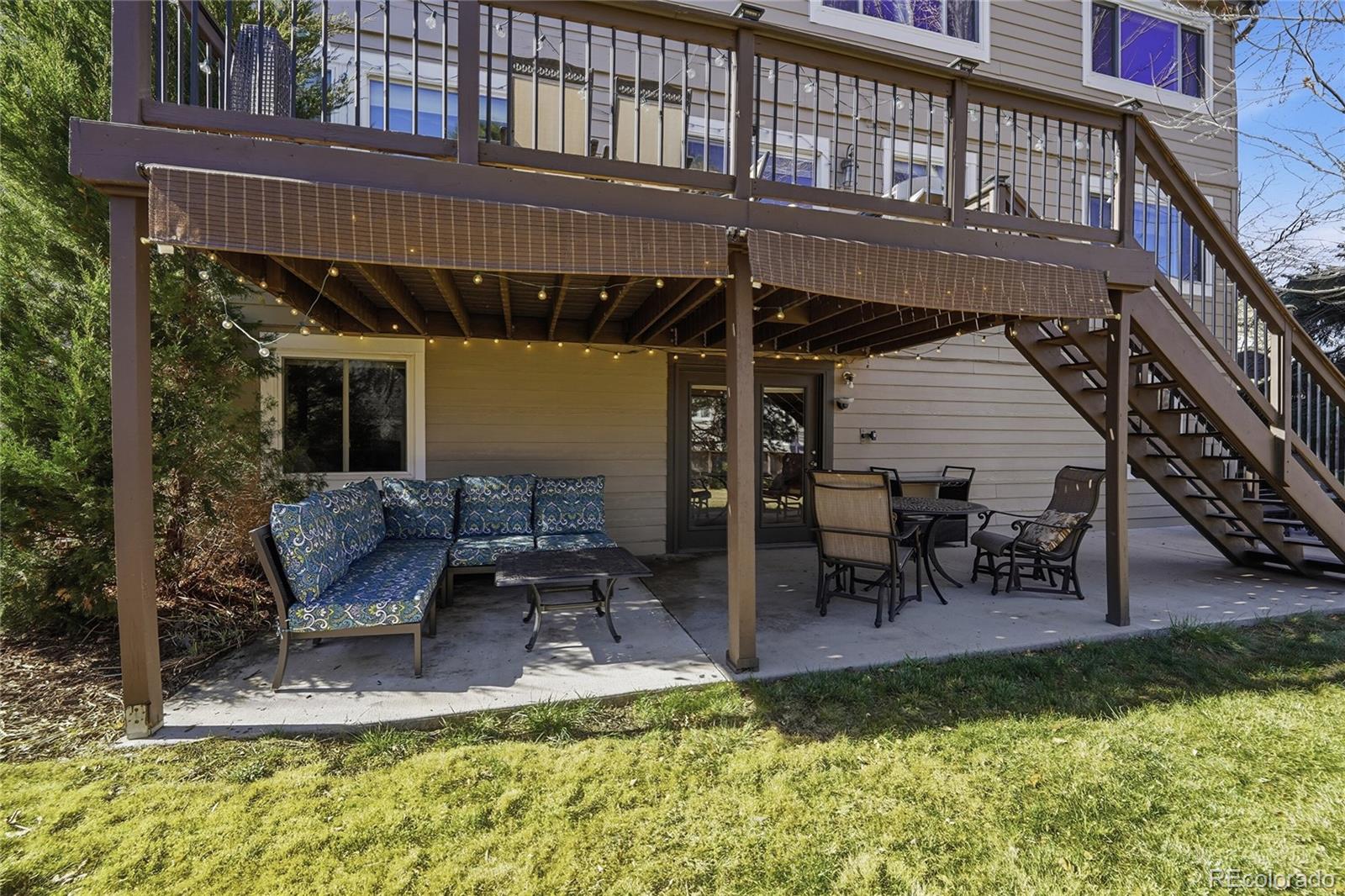 9264 Madras Court Highlands Ranch, CO 80130 - Photo 35 of 50 a view of a patio with table and chairs with wooden floor and fence
