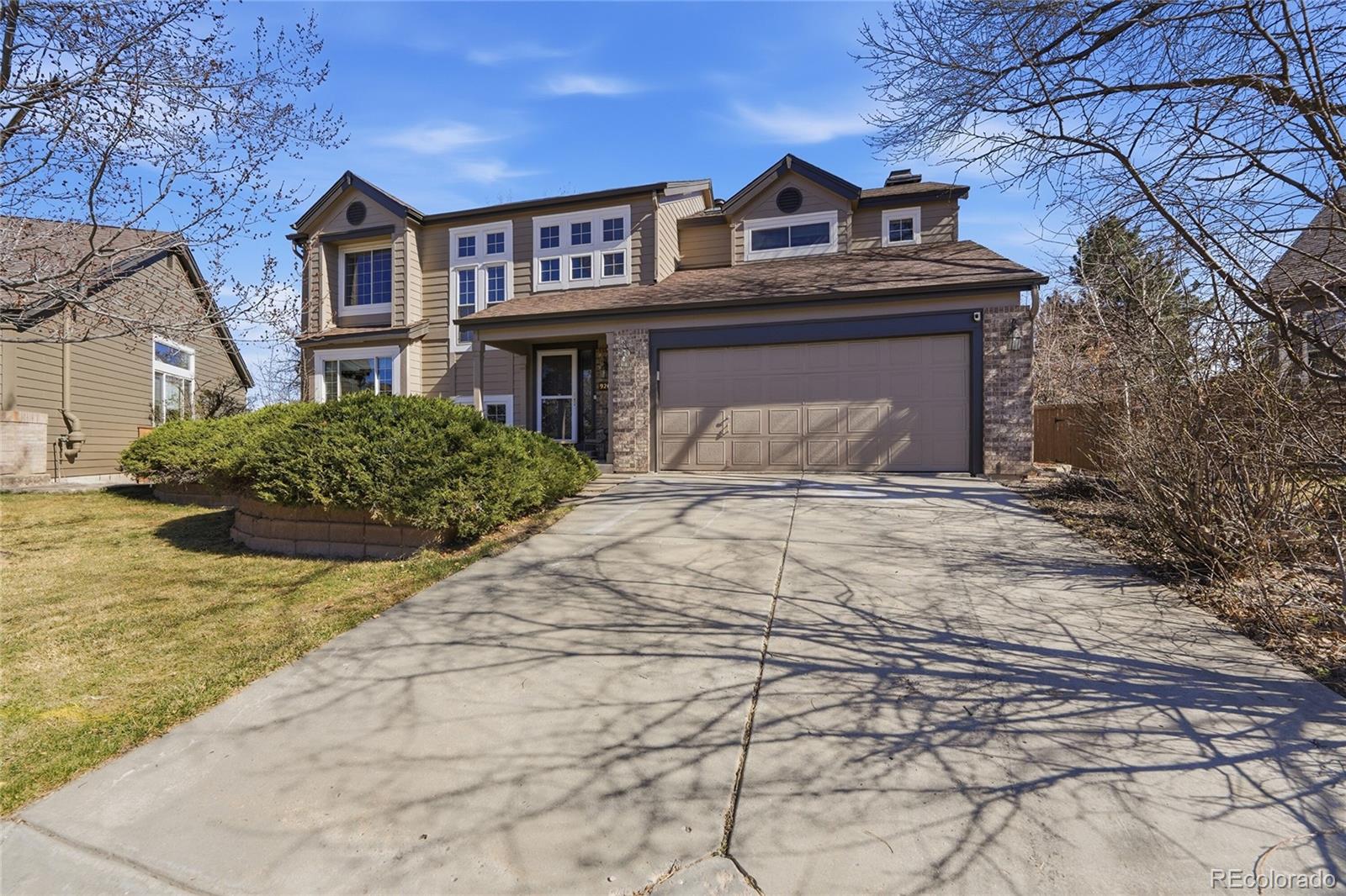 9264 Madras Court Highlands Ranch, CO 80130 - Photo 5 of 50 a front view of a house with a yard