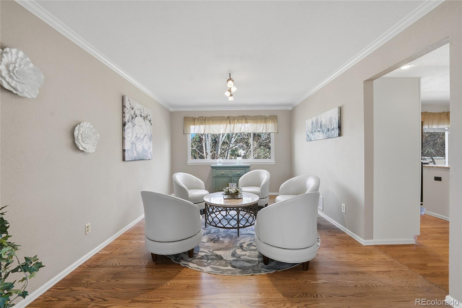 9264 Madras Court Highlands Ranch, CO 80130 - Photo 10 of 50 a dining room with wooden floor and a potted plant