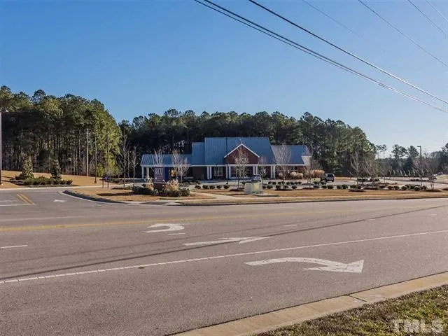 a view of street with houses and car parked on road