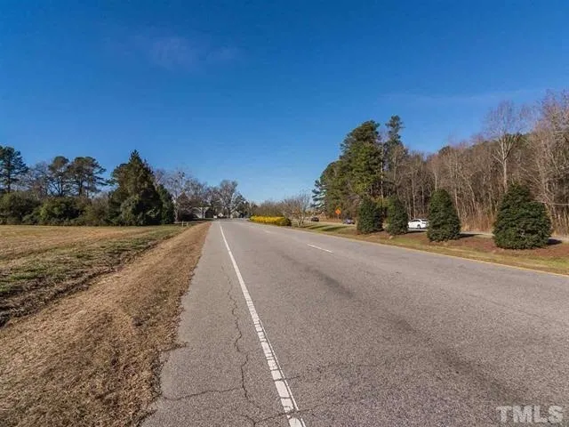 a view of a road with a building in the background