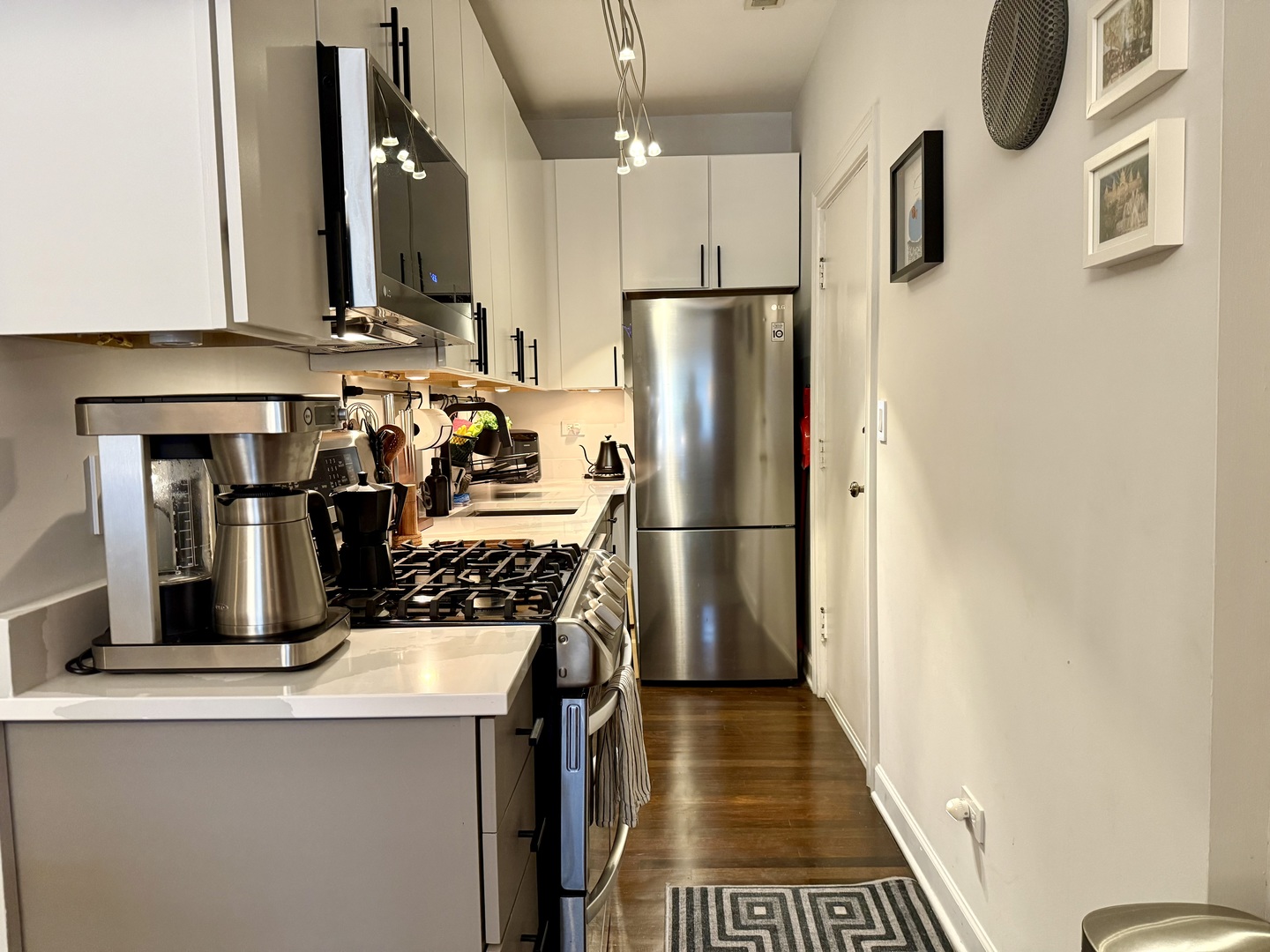 4720 North Beacon Street, Unit 2N Chicago, IL 60640 - Photo 14 of 26 a kitchen with stainless steel appliances a refrigerator a stove and a sink