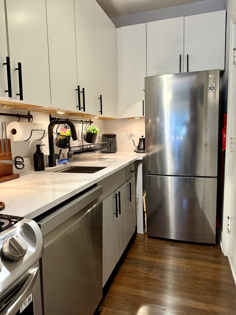 4720 North Beacon Street, Unit 2N Chicago, IL 60640 - Photo 15 of 26 a kitchen with stainless steel appliances a refrigerator and a sink