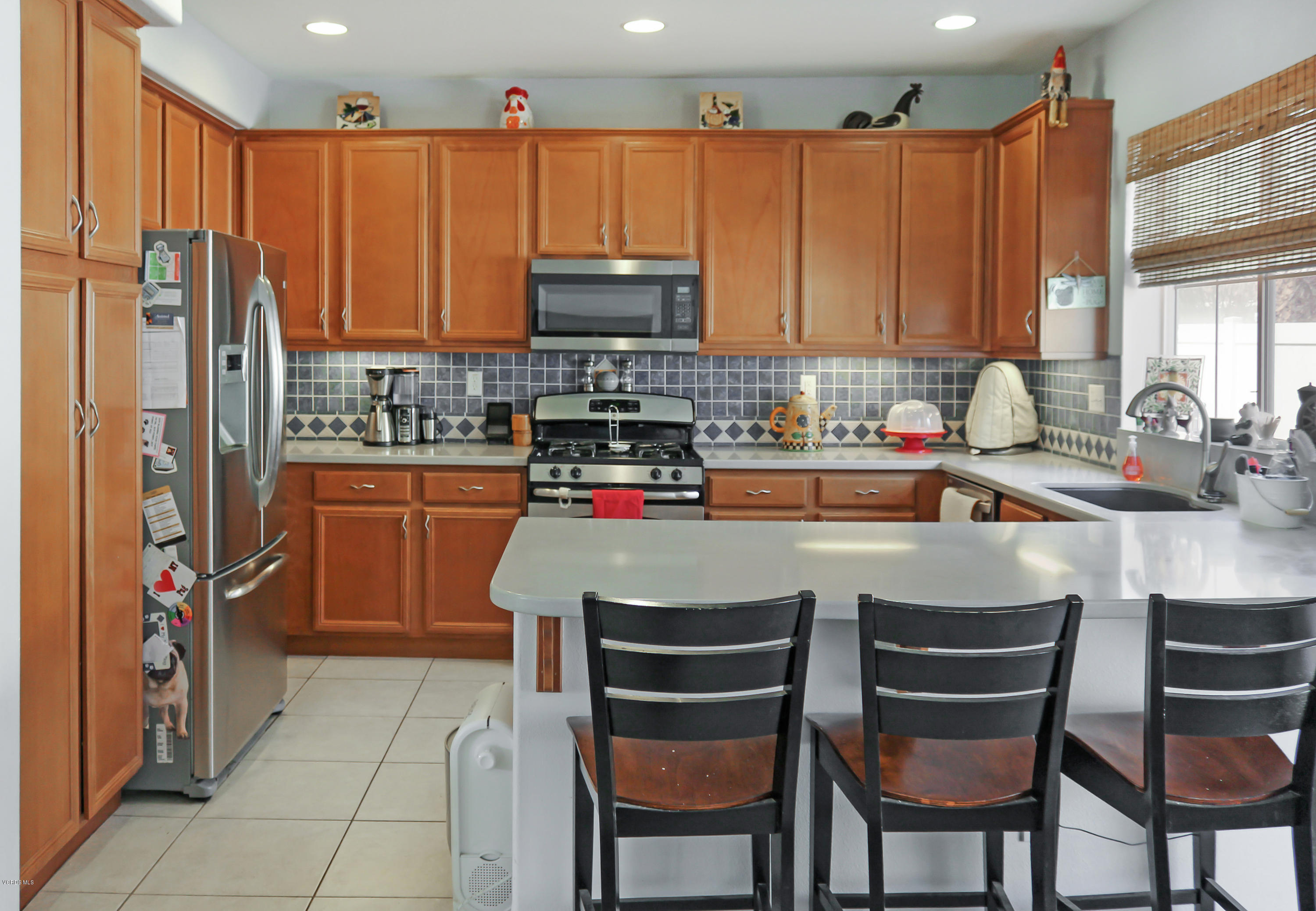 407 Field Street Oxnard, CA 93033 - Photo 3 of 15 a kitchen with stainless steel appliances granite countertop a stove a sink dishwasher and a refrigerator with wooden cabinets