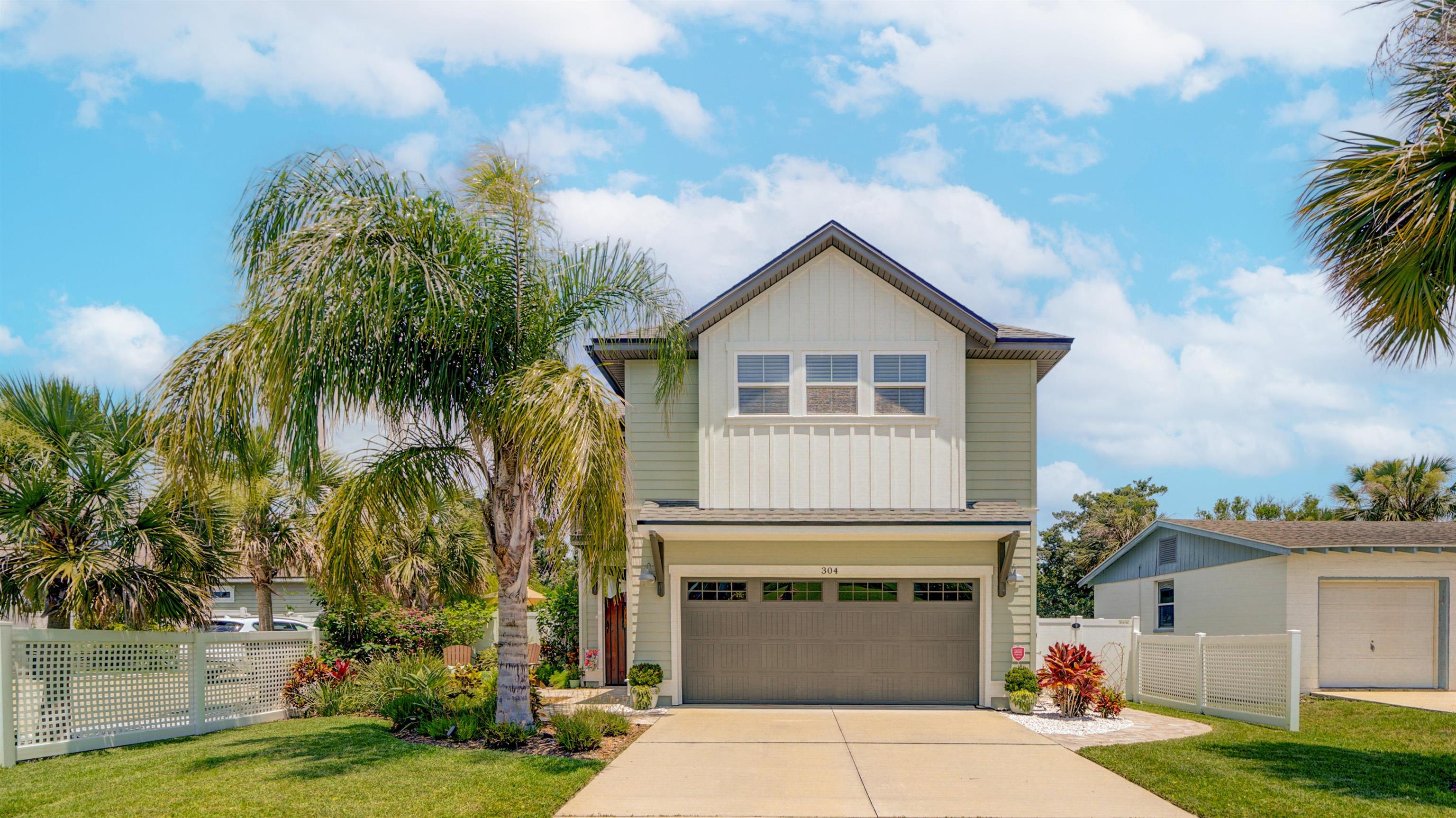 304 Ribault Street St. Augustine, FL 32080 - Photo 11 of 69 a front view of a house with a yard and garage