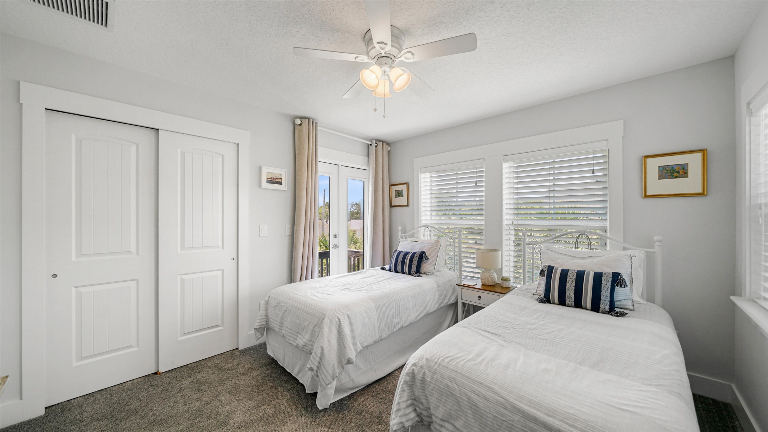 304 Ribault Street St. Augustine, FL 32080 - Photo 36 of 69 a spacious bedroom with two beds and a chandelier