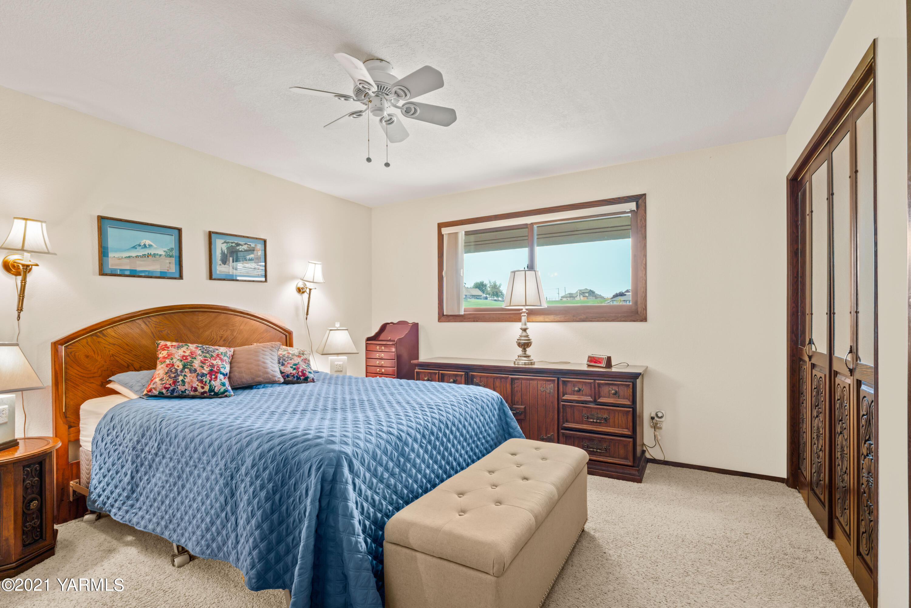 10906 Zier Road Yakima, WA 98908 - Photo 17 of 43 a bedroom with bed and a chandelier