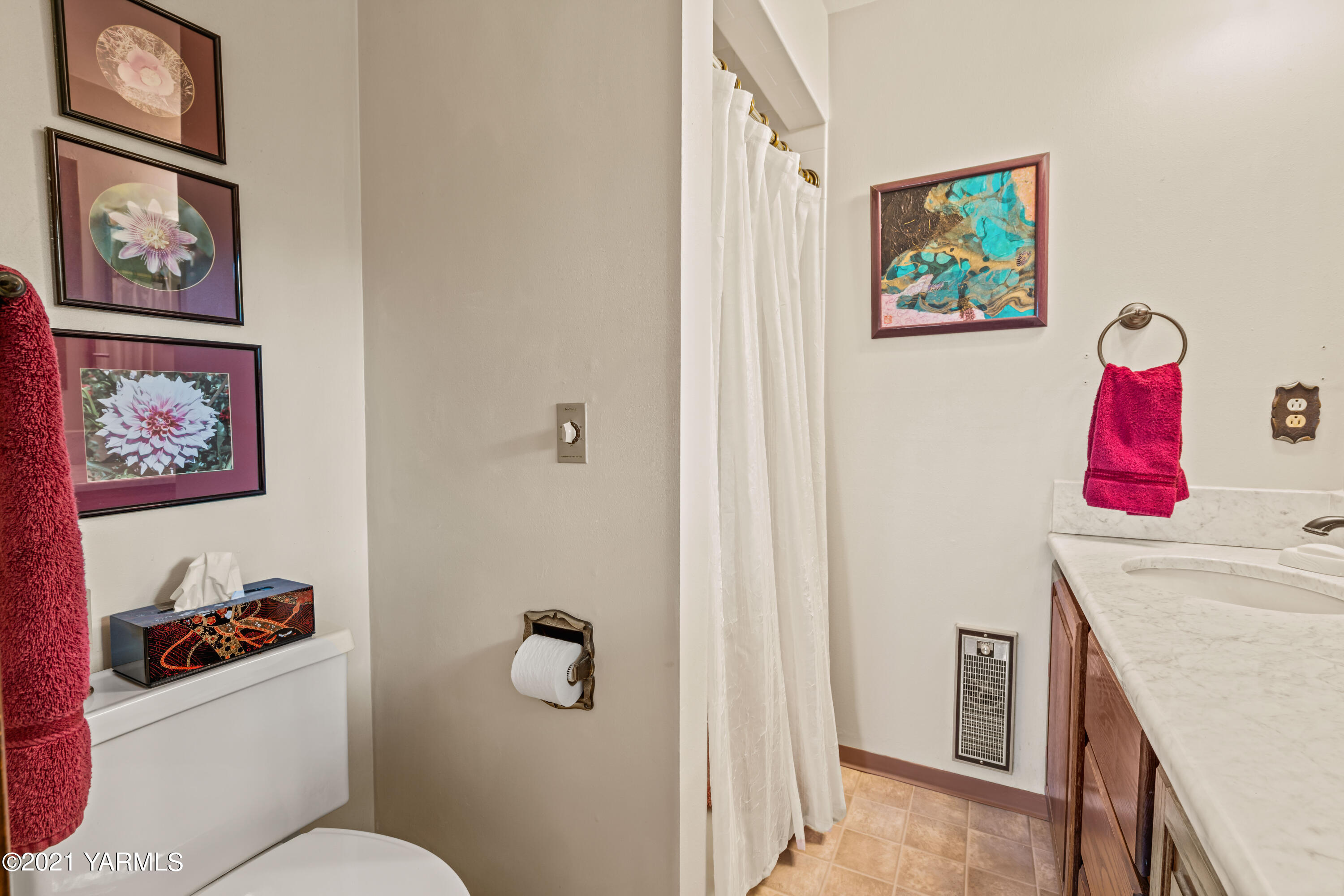 10906 Zier Road Yakima, WA 98908 - Photo 20 of 43 a bathroom with a painting on the wall and a wall painting