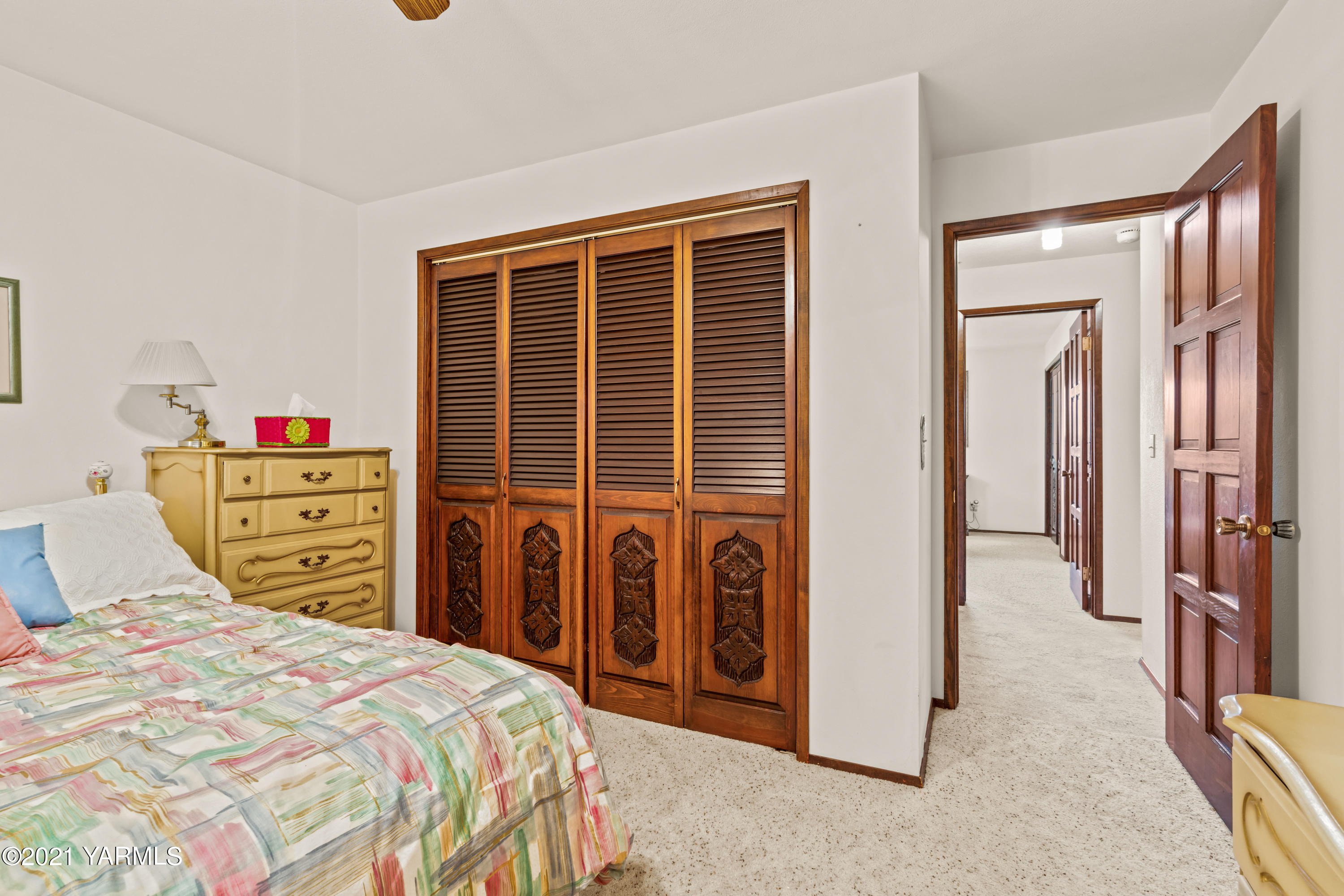 10906 Zier Road Yakima, WA 98908 - Photo 23 of 43 a bedroom with a bed a dresser and a large mirror