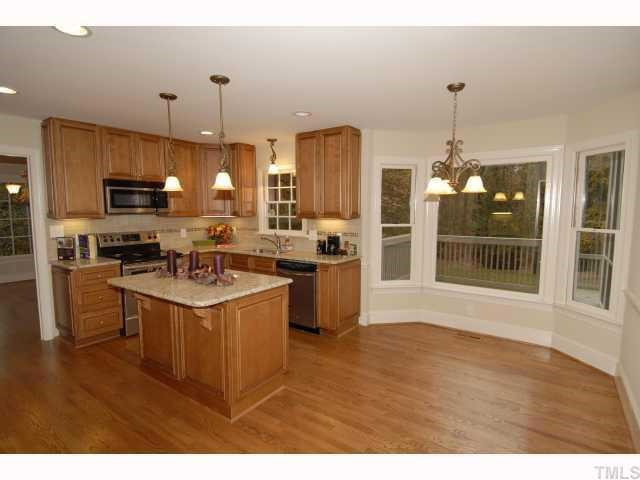 5229 Caber Road Raleigh, NC 27613 - Photo 2 of 12 Beautiful view of the wooded back yarda and you can watch the kids swim in your private fensed in pool. Kitchen