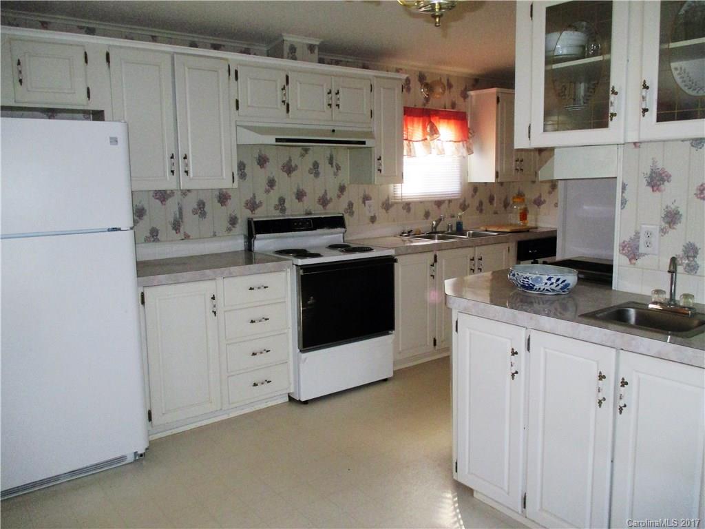 1640 Logan Terry Road, Unit 1 Lancaster, SC 29720 - Photo 17 of 24 a kitchen with granite countertop white cabinets white stainless steel appliances and sink