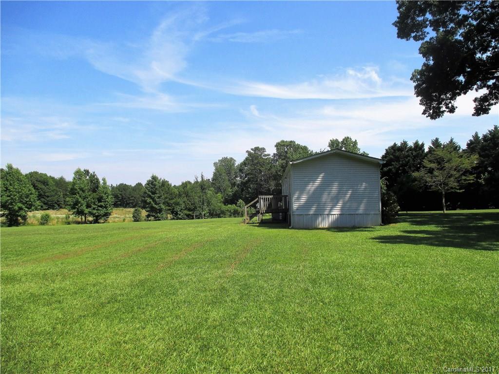 1640 Logan Terry Road, Unit 1 Lancaster, SC 29720 - Photo 18 of 24 a backyard of a house with lots of green space and mountain view in back