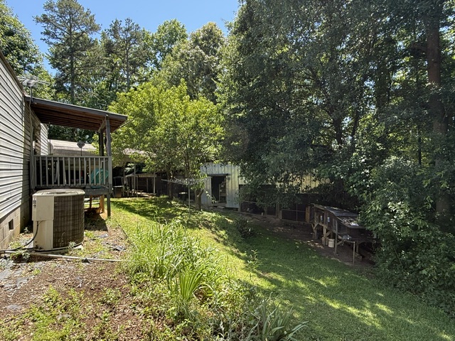 731 Glenn Ferry Road Fair Play, SC 29643 - Photo 18 of 23 A spacious backyard with mature trees, a private deck, and ample green space for outdoor activities.
