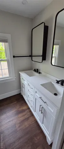a bathroom with a double vanity sink and mirror