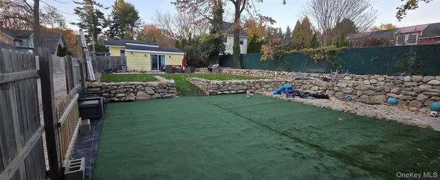 a view of house with backyard