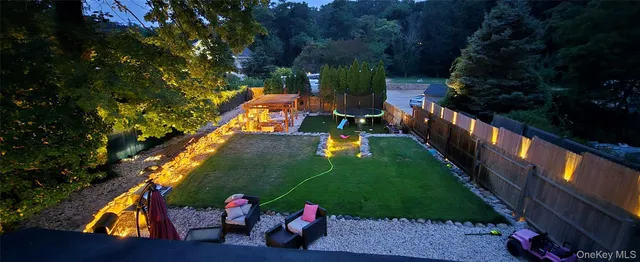 swimming pool view with a garden and outdoor seating