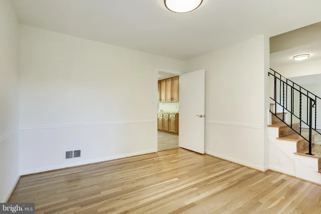 a kitchen with granite countertop a refrigerator stove and sink