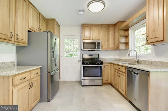 a bathroom with a sink a toilet and a window