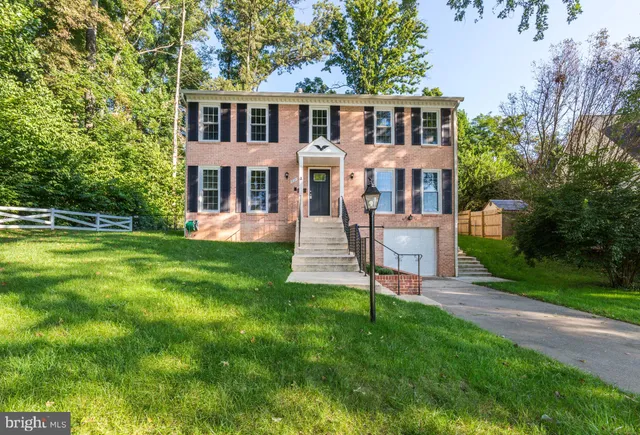 a front view of a house with a yard table and chairs